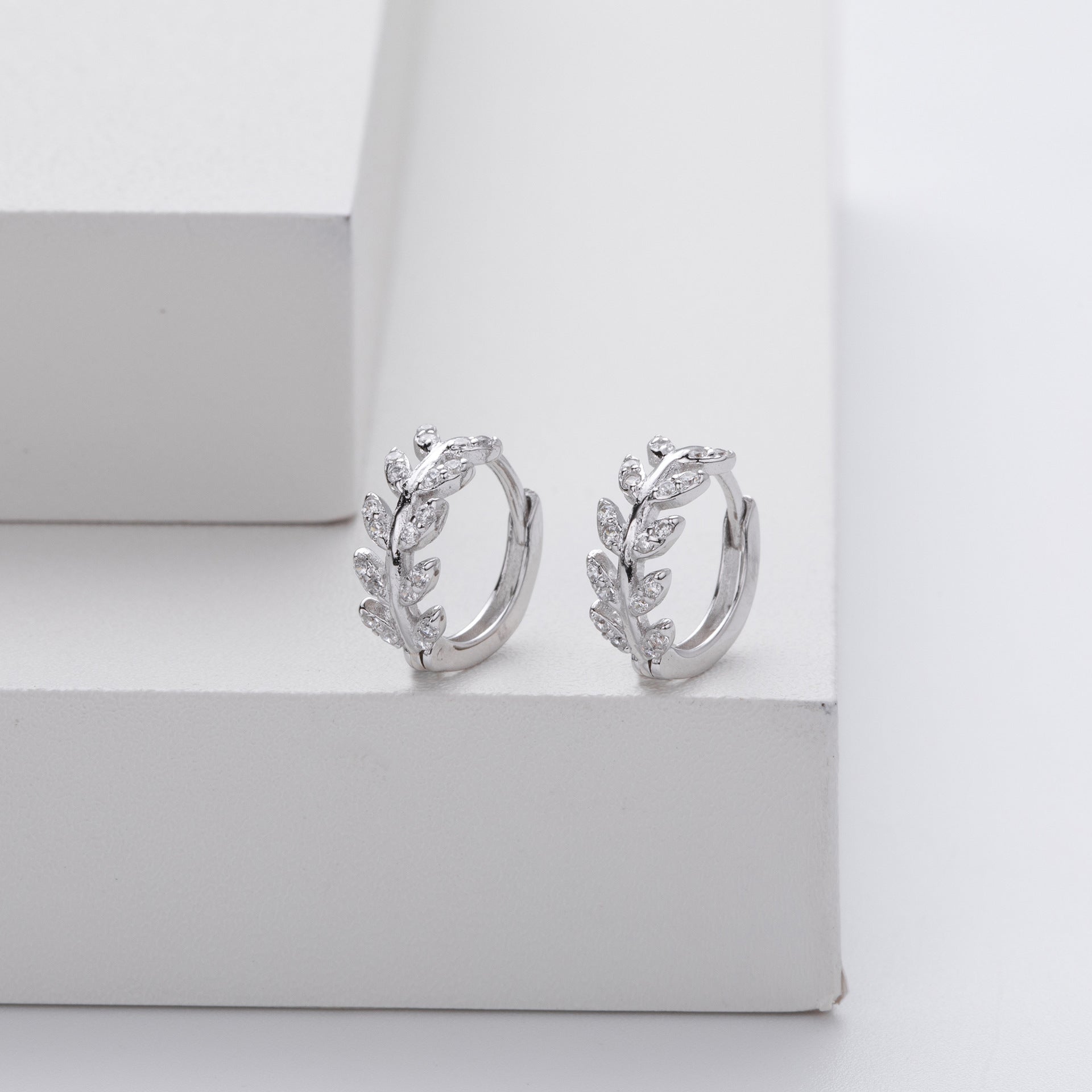 Silver earrings in the shape of a leaf