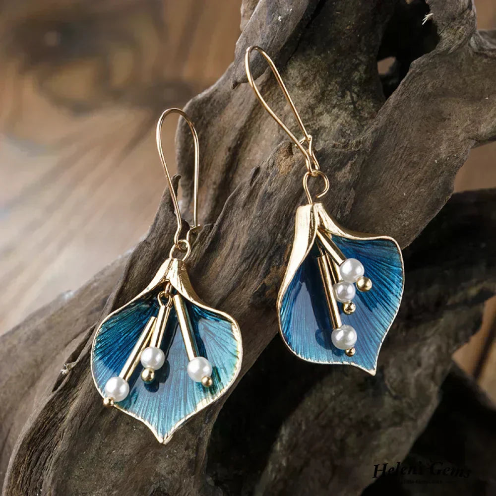 Golden and blue dangling earrings with pearls